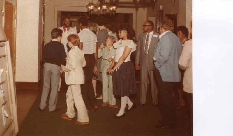 Guests and families gathered in a hallway during a university reception