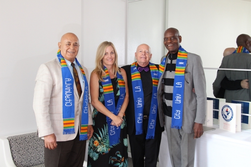 Four members of the university community wearing City University Los Angeles kente stoles