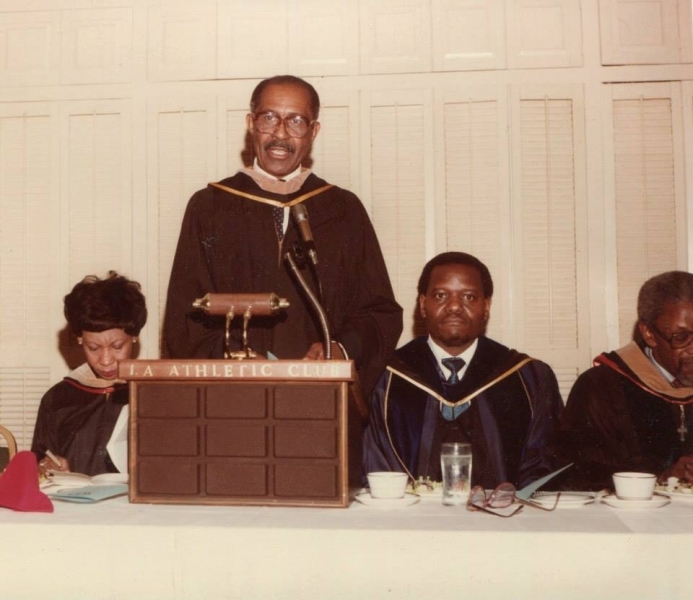 Faculty member in regalia giving the keynote address at the LA Athletic Club