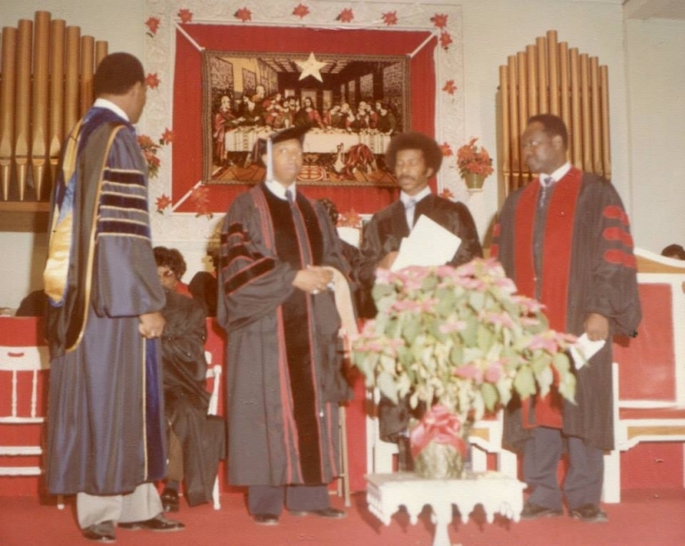 Faculty in doctoral regalia conferring a degree during a chapel ceremony