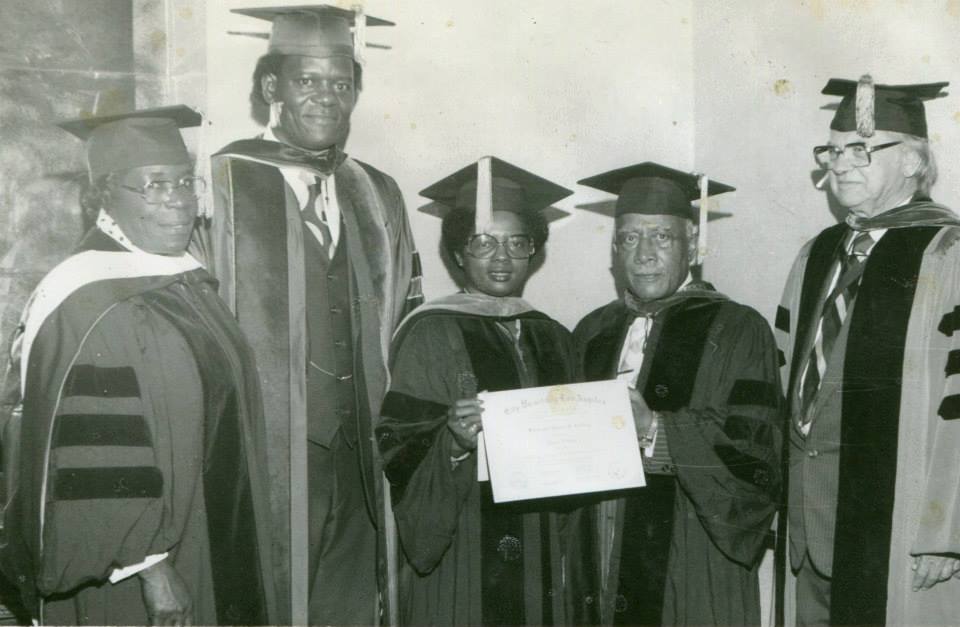 Five faculty members in regalia presenting a City University Los Angeles certificate