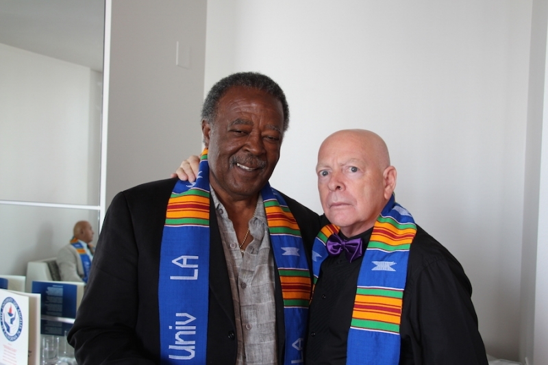 Portrait of two university colleagues in kente stoles