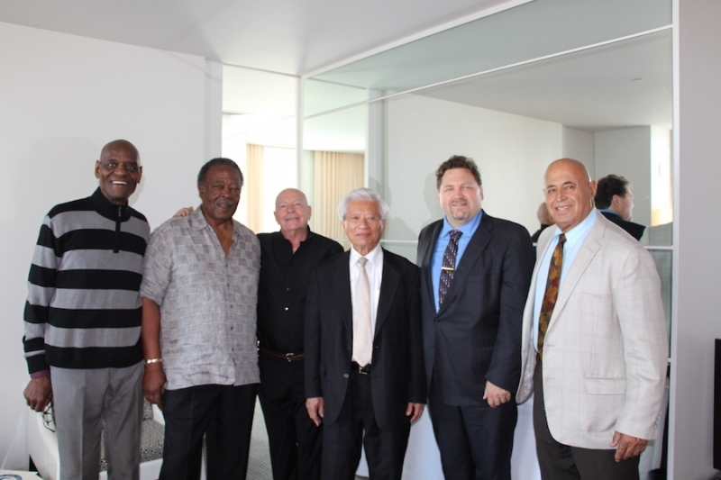 Six members of the university community standing together in a reception room