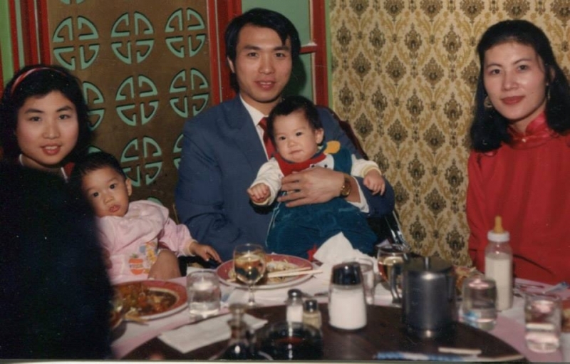 Family with young children seated at a celebratory dinner