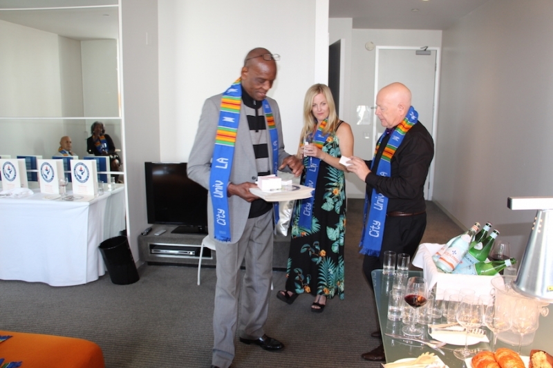 Guests in City University Los Angeles stoles gathering refreshments before the ceremony