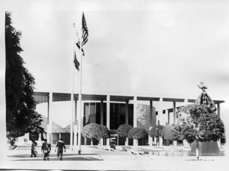 Historic black and white photograph of a Los Angeles civic building with flags