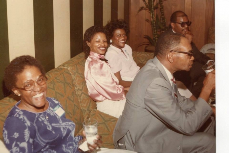 Guests seated together laughing during a university reception